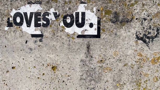 istock Torn paper on wall with 'LOVE YOU' 2152902167