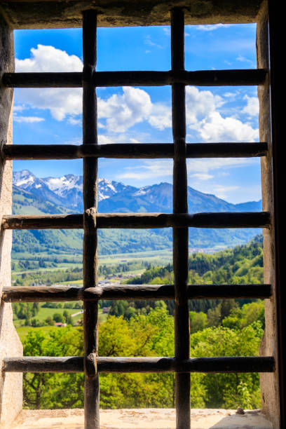 little window and shutter on a stoned facade of an old alpine chalet