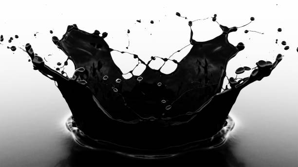 Black Oil Splash Forming Crown Shape on Reflective Surface