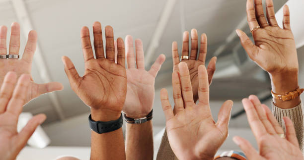 istock Business people, group and hands raised for question in closeup with training, development and workshop. Team work, men and women with sign for feedback, review or audience with vote in modern office 2152906925