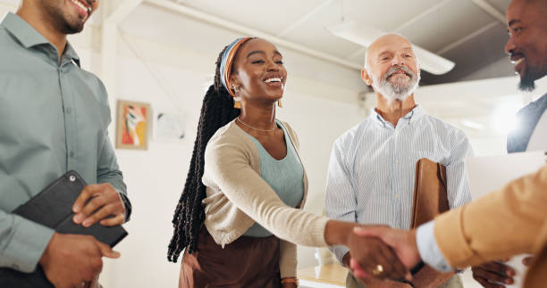 istock Thank you, handshake or business people with applause in office celebration for interview, onboarding or recruitment success. Welcome, praise and team clapping for woman shaking hands for hr contract 2152907615