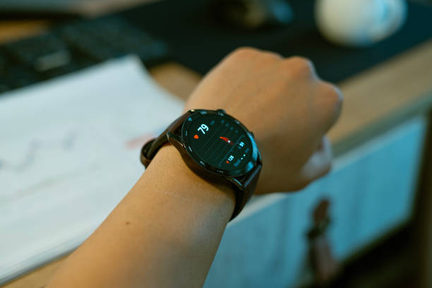istock Close-up Man doing health check on smartwatch while working at desk 2152907990