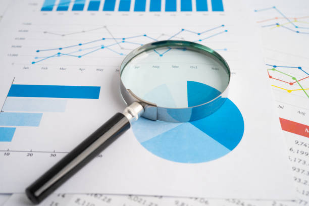 istock Magnifying glass on spreadsheet and graph paper. Financial development, Banking Account, Statistic, Investment Analytic research data economy, Business. 2152909680