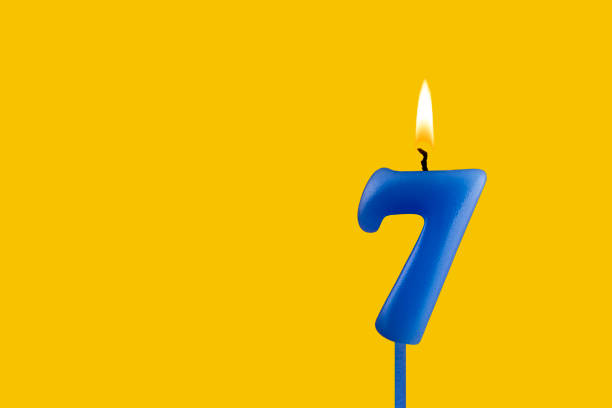 A close view of birthday cake with a candle on the table.