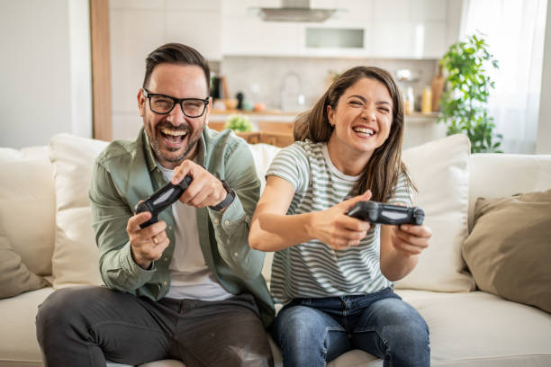 istock A couple is playing a video game, sitting on the sofa and using their free time to play video games on the console 2152914794
