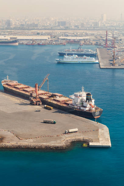 Bulk carrier ship in Jeddah Islamic Seaport Jeddah, Saudi Arabia - December 22, 2019: Bulk carrier ship in Jeddah Islamic Seaport on a sunny day, vertical photo, aerial view saudi arabia jeddah landscape stock pictures, royalty-free photos & images