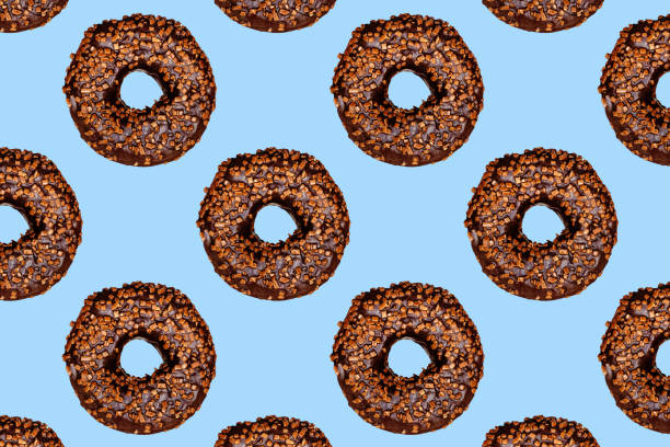 istock Creative pattern of chocolate donuts with holes on a blue background. 2152917591