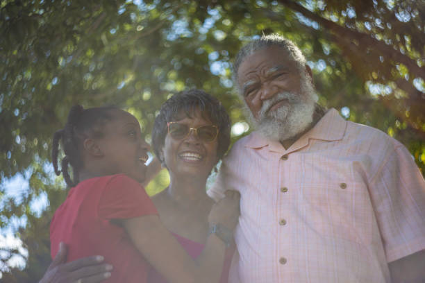 Vintage portrait of grandfather, grandmother and granddaughter. Joy on their faces. Retro photo 1995