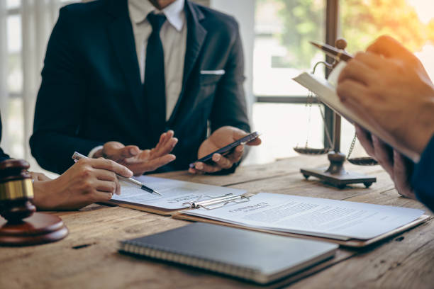 istock Lawyer working with client discussing contract documents with legal brass in consulting office to help client, close-up photo 2152918515