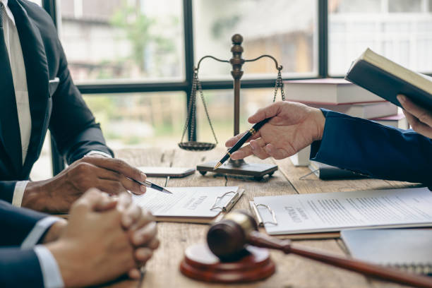 istock Lawyer working with client discussing contract documents with legal brass in consulting office to help client, close-up photo 2152918516