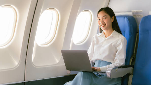 istock Professional Asian woman using laptop on airplane While sitting near the window in first class on an airplane during a flight travel concept 2152918549