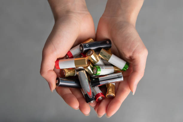 top view of hands with alkaline batteries