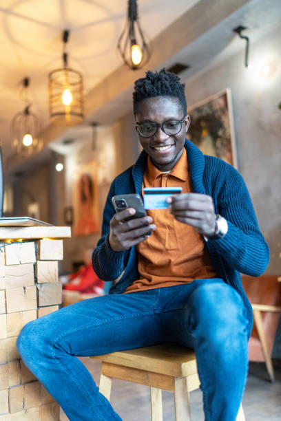 istock Cheerful young man paying online 2152918778