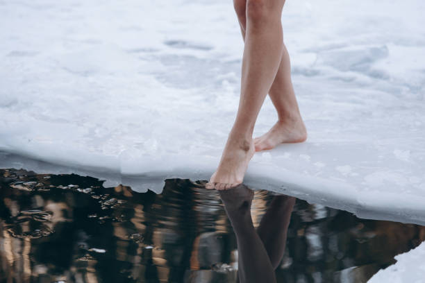 istock girl legs getting into ice cold water 2152921016