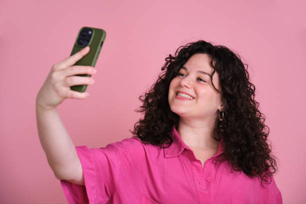istock A woman is taking a selfie with her cell phone 2152923224