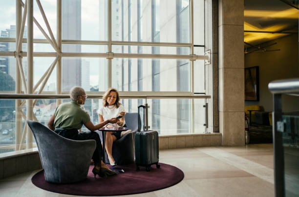 istock Business women discussing a project in hotel lobby 2152923265