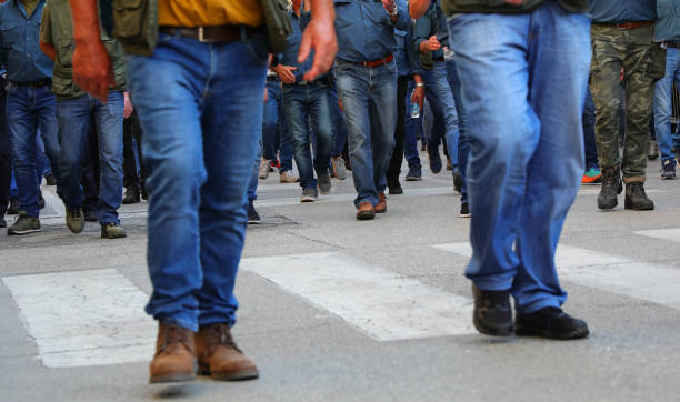 istock crowd of men walking down the street in jeans and their faces cannot be seen 2152923607