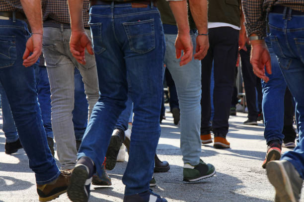 istock men walking down the street with their jeans photographed behind them 2152923627