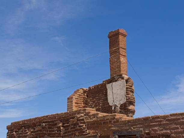 Chimney remains supported by guy wire and the historic Fort Davis in Texas.
