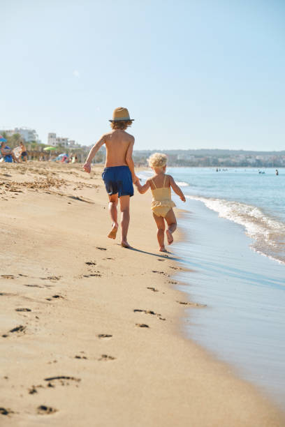 istock Children running on sandy beach in summer 2152929732