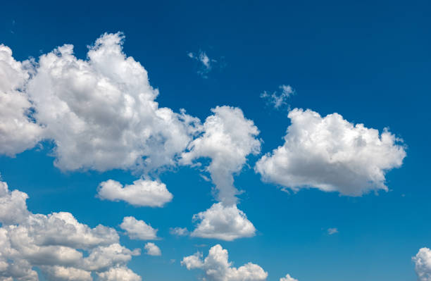 istock White fluffy clouds in the bright blue sky 2152930172