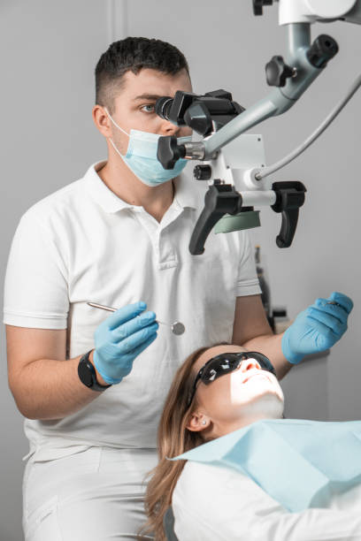 istock A dentist, confidently proficient in a microscopic approach to treatment, solves dental problems, providing the patient with an individual and high-tech approach. 2152932686