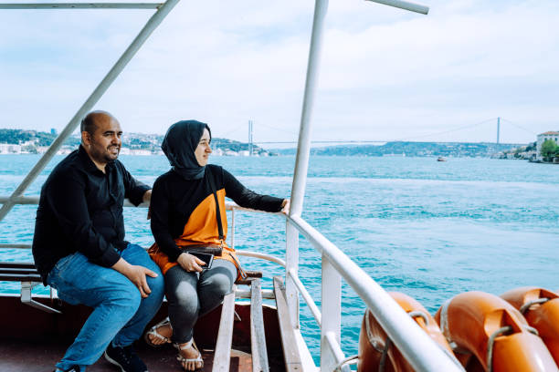June 6, 2022 editorial photo of a couple enjoying a scenic boat ride on the Bosphorus in Istanbul, Turkey.