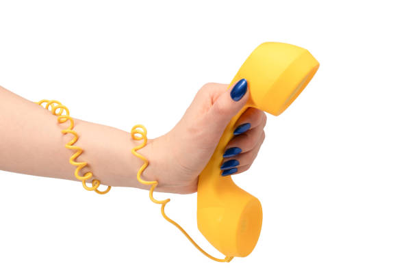 istock Yellow handset in woman hand isolated on white. Copy space. 2152934052
