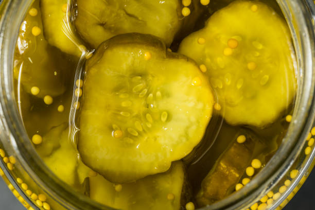 Organic Jarred Bread and Butter Dill PIckles Organic Jarred Bread and Butter Dill PIckles in Slices dill pickle stock pictures, royalty-free photos & images