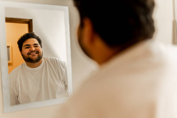 istock Young man looking at himself in the mirror at bathroom 2152937775