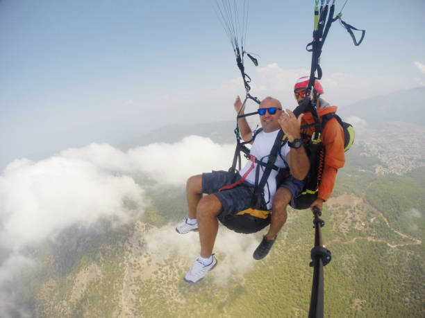 Paragliders jumping from Mount Babadag and flying against the backdrop of Oludeniz