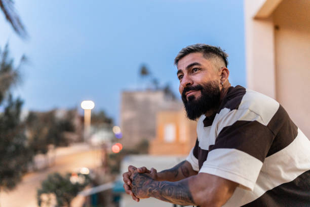 Mature man contemplating on balcony at home