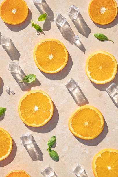 istock Sliced oranges with ice and mint leaves on a cream background 2152941184