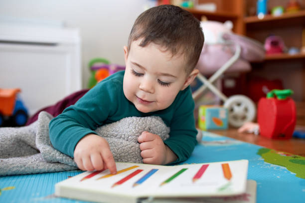 istock young boy playing and looking at books in his room 2152941493