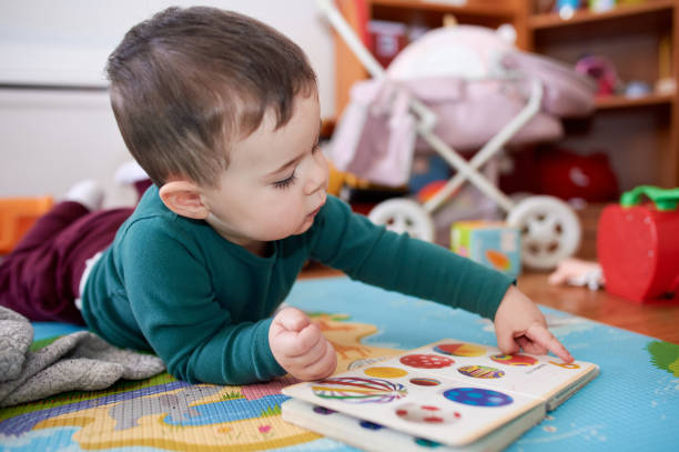istock young boy playing and looking at books in his room 2152941502