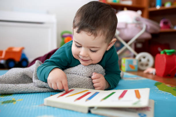 istock young boy playing and looking at books in his room 2152941503