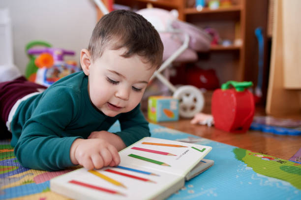 istock young boy playing and looking at books in his room 2152941509