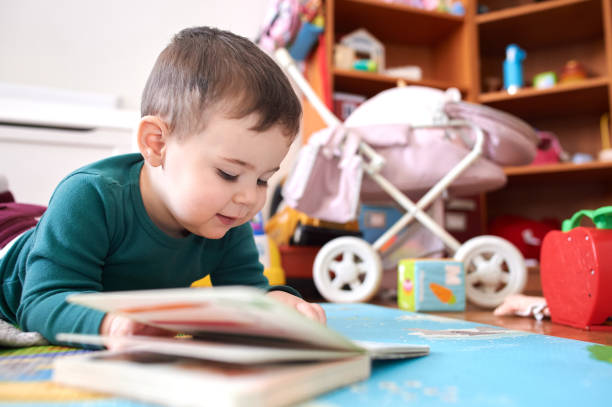istock young boy playing and looking at books in his room 2152941518
