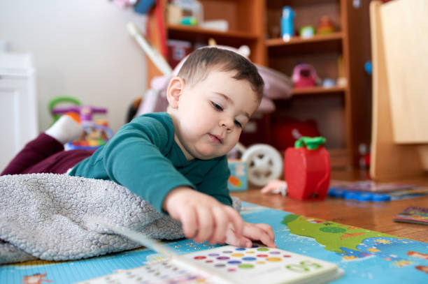 istock young boy playing and looking at books in his room 2152941522
