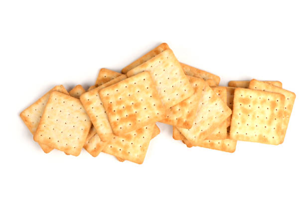 Many salt crackers, sticks, pretzels, and fishes, shot from aboveon a white background with a place for text. Party snacks mix, forming a frame with copy space