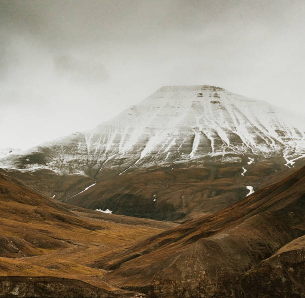 Snow-capped mountains with striations at dusk, Longyearbyen, Svalbard