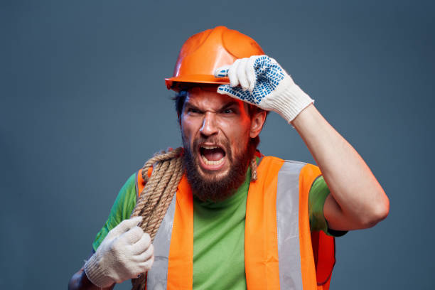 istock Man in work uniform orange paint rope in hands hard work cropped view 2152947276