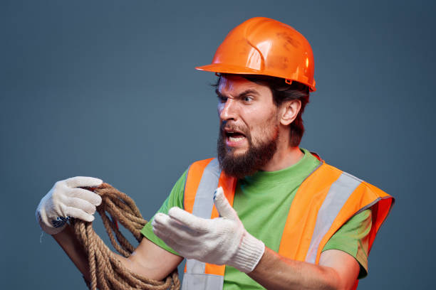 istock Man in work uniform orange paint rope in hands hard work cropped view 2152949021