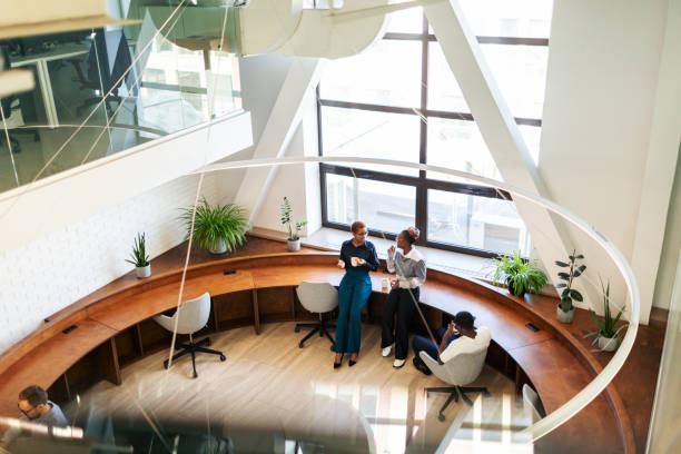 istock Colleagues having coffee break and chatting at the office 2152950883