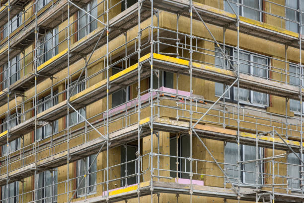 istock Fiberglass insulation cold barrier in facade on Construction site. Modern Building technologies and construction materials. New apartment building in Europe. Scaffolding around the wall. 2152951242