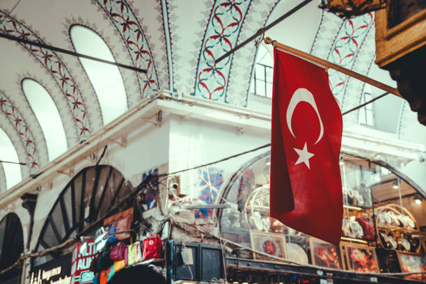 A vivid image of the iconic Turkish flag in the historic Grand Bazaar of Istanbul, showcasing cultural richness and architectural beauty.