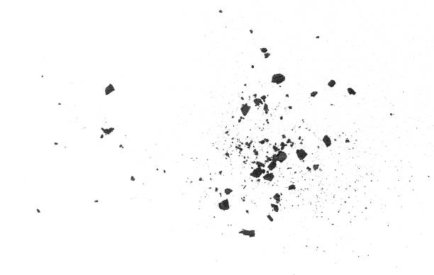 Black charcoal fragments isolated on a white background, view from above. Charcoal particles.