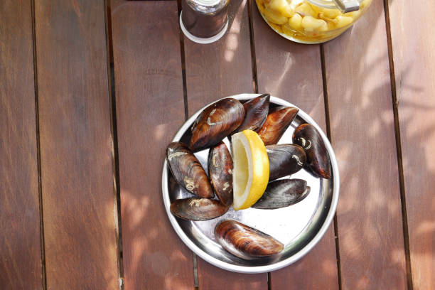 Thai mussels in metal on table top view .