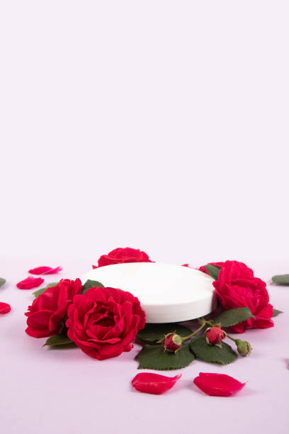 istock Empty podium with rose flowers on pink background 2152955396