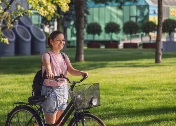 istock Beautiful young girl using bicycle in the city 2152956272